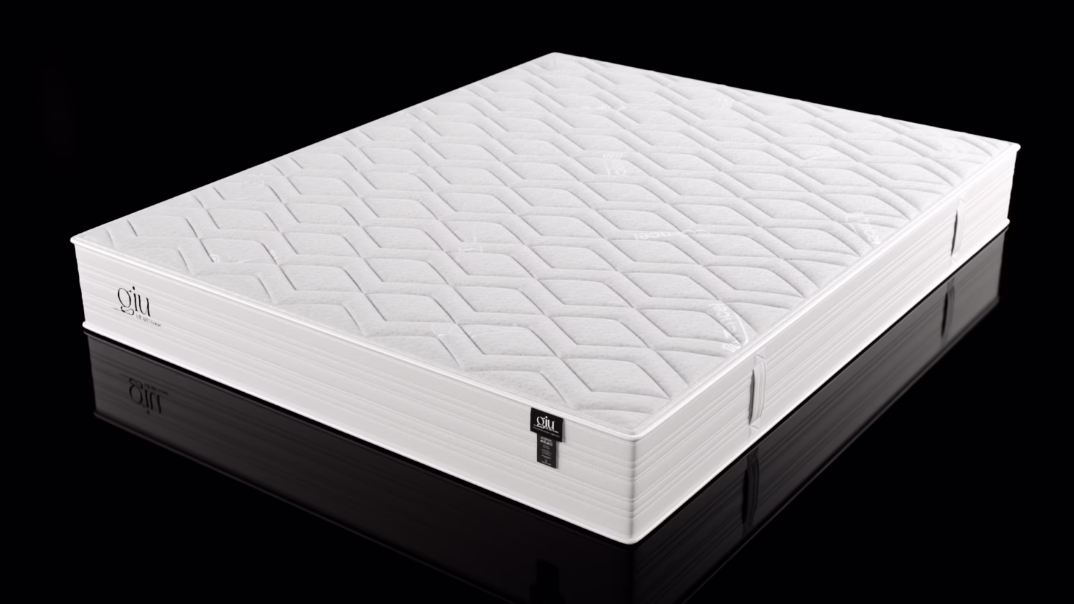 materac giu w białym pikowanym pokrowcu na czarnym tle